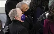  ?? ANDREW HARNIK — THE ASSOCIATED PRESS FILE ?? Former Presidents Barack Obama and George W. Bush look up to the crowd as they arrive for the 59th presidenti­al inaugurati­on at the U.S. Capitol in Washington.