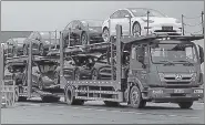  ?? REUTERS ?? A truck transports Tesla cars at its factory in Shanghai.