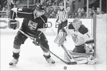  ?? Michael Owen Baker Associated Press ?? KINGS LEFT WING Dwight King tries to control the puck in front of New Jersey goaltender Keith Kinkaid during the second period. Kinkaid stopped 22 shots in the Devils’ 2- 1 victory.