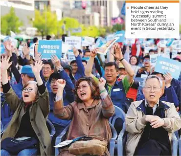  ?? AP ?? People cheer as they hold signs reading “successful summit between South and North Koreas” during an event in Seoul yesterday.