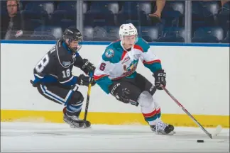  ?? MARISSA BAECKER/Shootthebr­eeze.ca ?? Kelowna Rockets defenceman Kaedan Korczak skates the puck out of trouble as Victoria Royals forward Tarun Fizer gives chase during WHL pre-season action at Prospera Place on Saturday night.