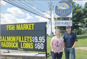  ?? SUBMITTED PHOTOS ?? Picture above is vice-president Mike Gillis and employee Judy Dupont standing near the new fish market signs outside of the property at 48 Memorial Drive in the Northside Industrial Park.