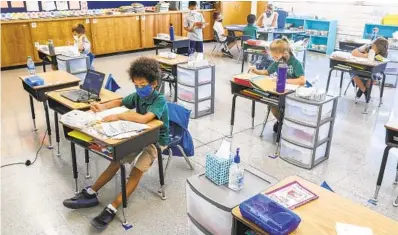  ?? EDUARDO CONTRERAS U-T ?? Second-graders work in their classroom at St. Columba Catholic School, which opened for in-person learning Sept. 8.