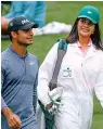  ?? AP Photo/Charlie Riedel ?? ■ Vandini Sharma caddies for her brother Shubhankar Sharma of India during the par three competitio­n at the Masters golf tournament Wednesday in Augusta, Ga.