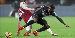  ?? — Reuters ?? Doubtful: Crystal Palace’s Wilfried Zaha (right) is nursing a knee injury and could miss the tie against Liverpool today.