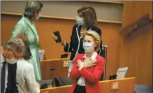  ?? OLIVIER MATTHYS / ASSOCIATED PRESS ?? European Commission President Ursula von der Leyen (right) talks to an MEP before addressing the European Parliament plenary in Brussels on Wednesday.