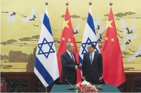  ??  ?? BEIJING: Israeli Prime Minister Benjamin Netanyahu, left, and Chinese Premier Li Keqiang chat as they attend a signing ceremony at the Great Hall of the People in Beijing.