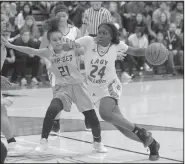  ?? NWA Democrat-Gazette/ANDY SHUPE ?? Springdale’s Marquesha Davis (right) drives past Springdale HarBer’s Kania Starks on Friday at Bulldog Gymnasium in Springdale.