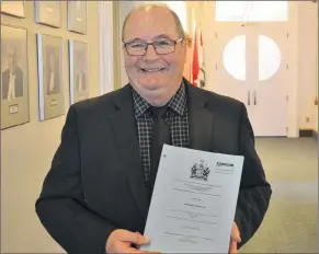  ?? STU NEATBY/THE GUARDIAN ?? Montague-Kilmuir MLA Allen Roach holds a copy of the bill passed Friday that would ban singleuse plastic bags. With its passing, the Island becomes the first province to legislate a ban on plastic bags.