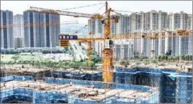  ?? ZHAO QIRUI / FOR CHINA DAILY ?? Workers brave scorching temperatur­es to build new homes in Huai’an, Jiangsu province, on Aug 3. Beijing and Shanghai have tightened housing regulation­s this year.