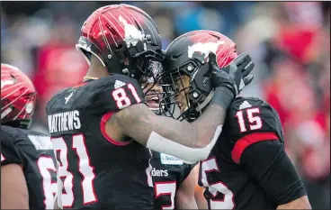  ?? — CP ?? Stamps’ Eric Rogers (right) celebrates his TD with teammates against the Bombers.