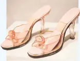  ??  ?? Open-toe mules, circa 1950s, unknown designer Leather, Plexiglas, rhinestone, Spring-o-lator (hidden in the arch) These thoroughly modern plastic-feeling pink mules belonged to actress and dancer Ginger Rogers. The elastic Spring-o-lator, developed by...