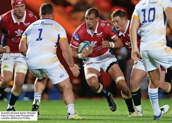  ?? ?? Scarlets forward Aaron Shingler tries to find a way through the Leinster defence on Friday.