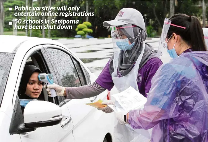  ?? — CHAN BOON KAI/ The Star ?? Safety measure: A student having her temperatur­e taken before entering USM for its 2020/2021 intake.
