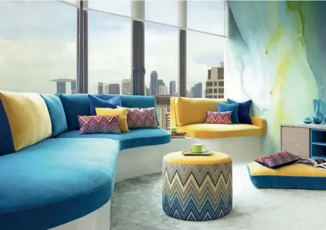  ??  ?? The eye-catching array of blue and yellow shades create a lively setting in this seating areaA playful mix of monochroma­tic patterns adds a lively energy to the interior scheme; Andrea Savage and Nikki Hunt of Design Interventi­on THIS PAGE OPPOSITE PAGE