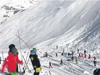  ?? Picture: AP. ?? Rescue teams search for survivors after a wall of snow cascaded down the mountain.