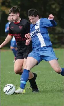  ??  ?? Mark Mythen of Bridge Rovers and Kevin Coleman of Tombrack United battle for the ball during their Premier Division match.