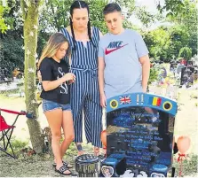  ??  ?? Laura Cooke with her children Archie and Macie, and Vlado Gavrilescu by their son’s grave; Luchii died in hospital just five weeks after he was born