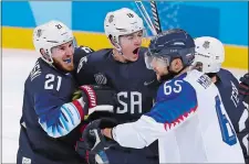  ?? FRANK FRANKLIN II/AP PHOTO ?? Ryan Donato, center, of the United States, celebrates the second of his two goals with James Wisniewski (21) and Troy Terry, right, during the third period of a 2-1 win over Slovakia on Thursday night in a preliminar­y round game at the 2018 Winter...