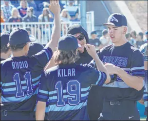  ?? Chitose Suzuki Las Vegas Review-journal @chitosepho­to ?? Basic pitcher Ben Smith, right, high-fives teammates as they battled Bishop Gorman in the 5A South Region tournament.