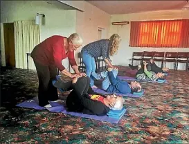  ??  ?? Taranaki Parkinson’s Society Community educator Adell Morton and yoga teacher Catherine O’Neil take a class for people with the condition.