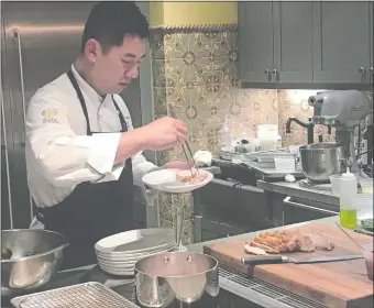  ?? ERICA MOSER/THE DAY ?? Ocean House Executive Chef Matt Voskuil adds turkey leg confit to a plate with sous vide turkey breast.