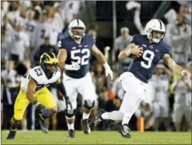  ?? CHRIS KNIGHT — THE ASSOCIATED PRESS ?? Penn State quarterbac­k Trace McSorley (9) takes off running against Michigan during the first half of an NCAA college football game in State College, Pa., Saturday.