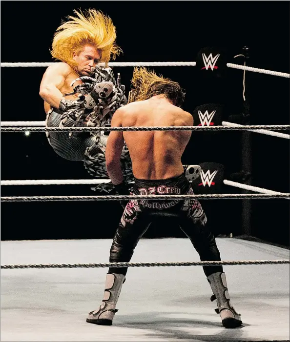  ?? — THE ASSOCIATED PRESS FILES ?? WWE wrestler Tyler Breeze, left, kicks Dolph Ziggler during the WWE Live India Tour in New Delhi earlier this year. The Penticton native says many profession­al wrestlers helped influence his character, including Terry Taylor, Billy Gunn and Norman...