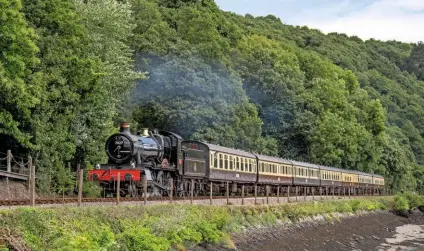  ?? KENNY FELSTEAD ?? ‘Manor’ No. 7827 Lydham Manor climbs away from Kingswear near Britannia Crossing on July 6, the day the Dartmouth Steam Railway reopened to the public – one of the first standard gauge lines to do so.