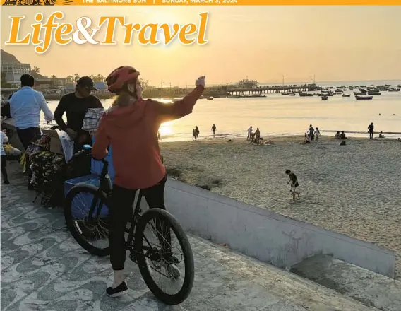  ?? COLLEEN THOMAS/TNS PHOTOS ?? Cyclists on a bike tour stop to gaze at the view along the oceanfront in Lima, Peru.