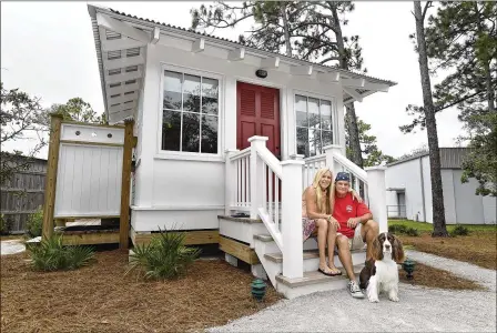  ?? Northwest Florida Daily News
PHOTOS BY DEVON RAVINE / NORTHWEST FLORIDA DAILY NEWS VIA ASSOCIATED PRESS ?? Mary McGuigan and John Walden relax with their dog Dude on the porch of the mini cottage they built in the Panhandle community of Seagrove Beach. Including the deck and outdoor shower, the house is just less than 300 square feet. Walden said the cost...