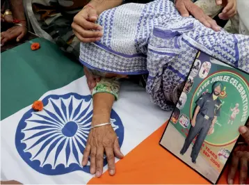  ?? — PTI ?? Late Naib Subedar Paramjit Singh’s mother mourns near her son’s body on its arrival at their village Vain Poin, some 40 km from Amritsar