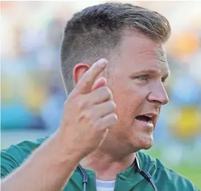  ?? ADAM WESLEY/USA TODAY NETWORK-WISCONSIN ?? Packers general manager Brian Gutekunst talks to coaches before a preseason game against the Titans earlier this summer at Lambeau Field.