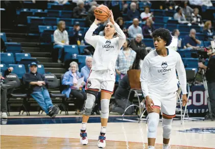  ?? JESSICA HILL/AP ?? Azzi Fudd warms up before Uconn’s game against Xavier on Monday at Gampel Pavilion. Her coach, Geno Auriemma, says she’s progressin­g but isn’t ready to declare her back and ready to play.