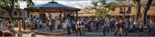  ?? NATHAN BURTON/Taos News ?? A packed plaza enjoys music by local band Chicken Sedan at Taos Plaza Live in July 2021. The band’s sound is all-Americana, rockabilly, surf, hot rod twang and country.