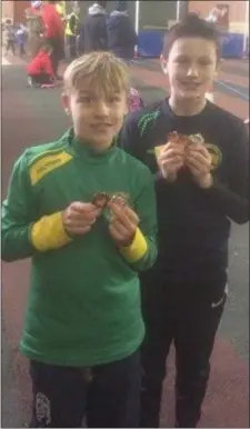  ??  ?? Oliver Carolan and Aaron Fennell with their medals at the Cushinstow­n AC Track & Field.