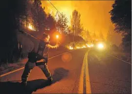  ?? Wally Skalij Los Angeles Times ?? TYLER BENSON throws a flare as the Delta fire burns on Pollard Camp Road north of Redding. The blaze has burned 47,110 acres and closed part of I-5.