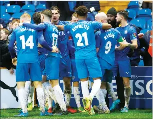  ?? PIC: Mike Petch ?? MADD AS A HATTER: Paddy Madden is mobbed after his late goal