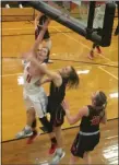  ?? DAVID S. GLASIER — THE NEWS-HERALD ?? Cornerston­e Christian forward Michaela Cloonan shoots and scores over two Buckeye Central defenders March 7.