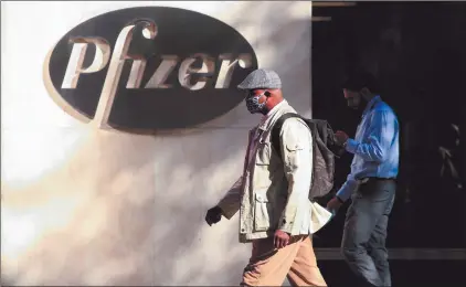  ?? Photo: Nampa/AFP ?? Boost… People walk by the Pfizer world headquarte­rs in New York.