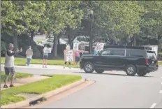  ?? Alex Brandon / Associated Press ?? Protesters and supporters react as the motorcade for President Donald Trump arrives at Trump National Golf Club on Saturday in Sterling, Va. He played golf and tweeted.