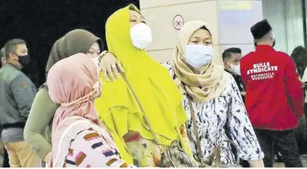  ?? (Photo: AP) ?? Relatives of passengers arrive at a crisis centre set up following a report that a Sriwijaya Air passenger jet has lost contact with air traffic controller­s shortly after take off, at Soekarno-hatta Internatio­nal Airport in Tangerang, Indonesia,saturday.
