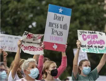  ?? AP ?? DESPERATIO­N, HOPE: People attend the Women's March ATX rally at the Texas State Capitol in Austin on Oct. 2.