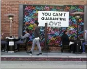  ?? MARCIO JOSE SANCHEZ — THE ASSOCIATED PRESS ?? A COVID-19-themed mural reads “You Can’t Quarantine Love,” outside of a restaurant Monday in Santa Monica, Calif.