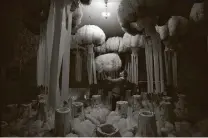  ?? Virginia Mayo / Associated Press ?? Tailor Karl Kersten shows off elaborate ostrich feather headdresse­s usually worn during Belgium’s Binche carnival.