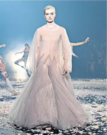  ??  ?? Model Ruth Bell walks the rose petal-strewn runway at the Christian Dior show at Paris Fashion Week