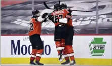  ?? DERIK HAMILTON — THE ASSOCIATED PRESS ?? Flyers’ Samuel Morin, right, celebrates with Shayne Gostisbehe­re (53) and Nicolas Aube-Kubel after scoring a goal against the Rangers during the third period.