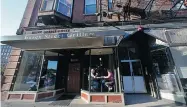  ??  ?? Diners sit at a table inside the Essex Street Grille in Haverhill, Mass. — a city hungry to reinvent its public image.