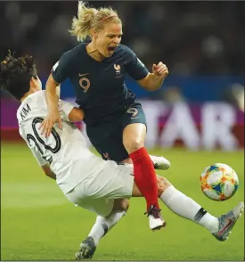  ?? LIONEL BONAVENTUR­E/AFP/GETTY IMAGES/TNS ?? France forward Eugenie Le Sommer, right, vies with South Korea defender Hye-Ri Kim during the France 2019 Women's World Cup Group A match on Friday in Paris. France won, 4-0.