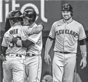  ?? AP ?? Guardians players Steven Kwan, left, Tyler Freeman, center, and Luke Maile, right, celebrate after Kwan hit a grand slam Sunday in a 10-4 win against the Rangers.